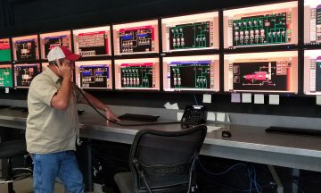 A central utility plant operator on the phone in a control room