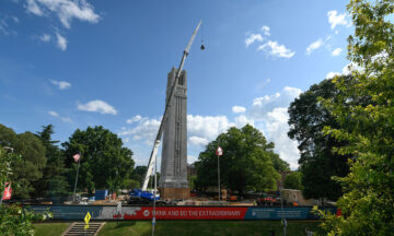 crane holding bell to be installed in the top of the belltower